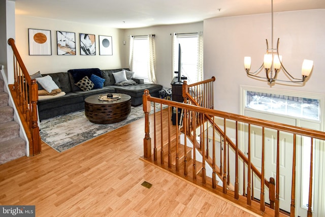 living room with wood-type flooring and a chandelier