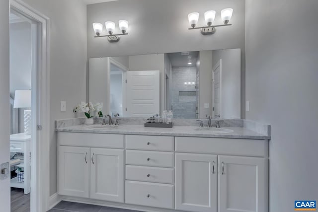 bathroom featuring tile patterned flooring, an enclosed shower, and vanity