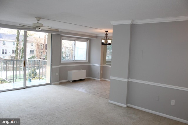 carpeted spare room with radiator heating unit, ceiling fan with notable chandelier, and ornamental molding