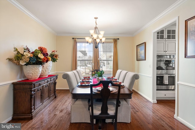 dining room with ornamental molding, dark hardwood / wood-style floors, and a notable chandelier