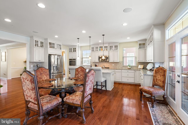 dining area featuring crown molding and dark hardwood / wood-style flooring