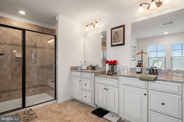 bathroom with vanity and a shower with shower door