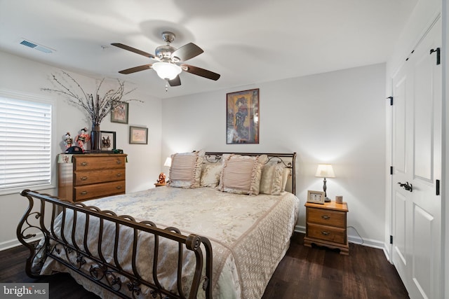 bedroom with dark hardwood / wood-style floors, ceiling fan, and a closet