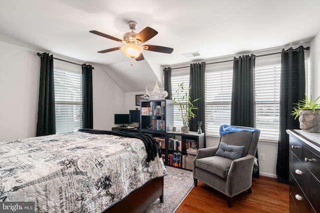 bedroom with dark hardwood / wood-style flooring, lofted ceiling, and ceiling fan