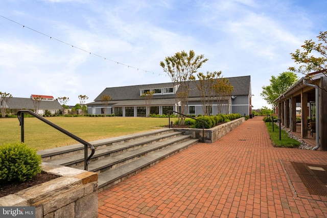 rear view of property featuring a lawn