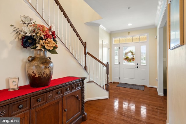 entryway featuring hardwood / wood-style flooring and ornamental molding