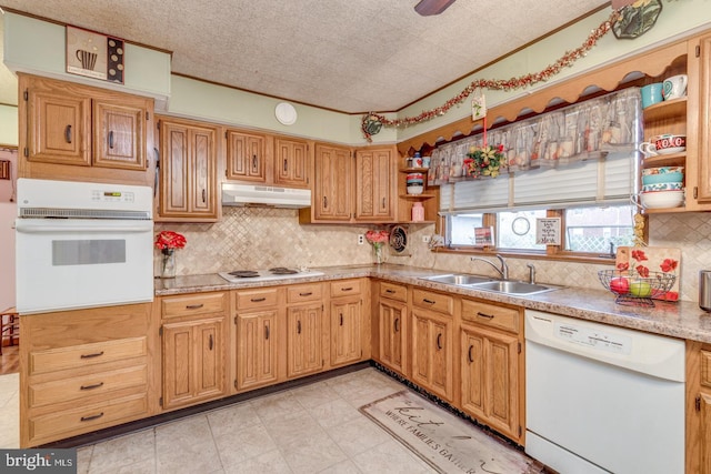 kitchen with sink, decorative backsplash, white appliances, crown molding, and a textured ceiling