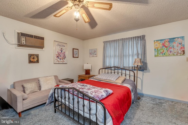 carpeted bedroom featuring ceiling fan, a wall mounted air conditioner, and a textured ceiling