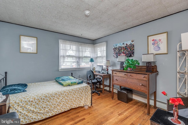 bedroom featuring a textured ceiling and light wood-type flooring