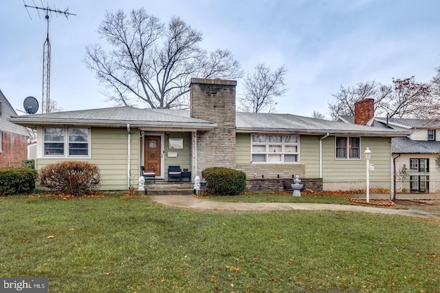 back of property featuring a lawn