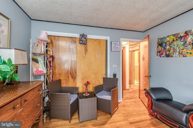 sitting room with a textured ceiling and light hardwood / wood-style floors