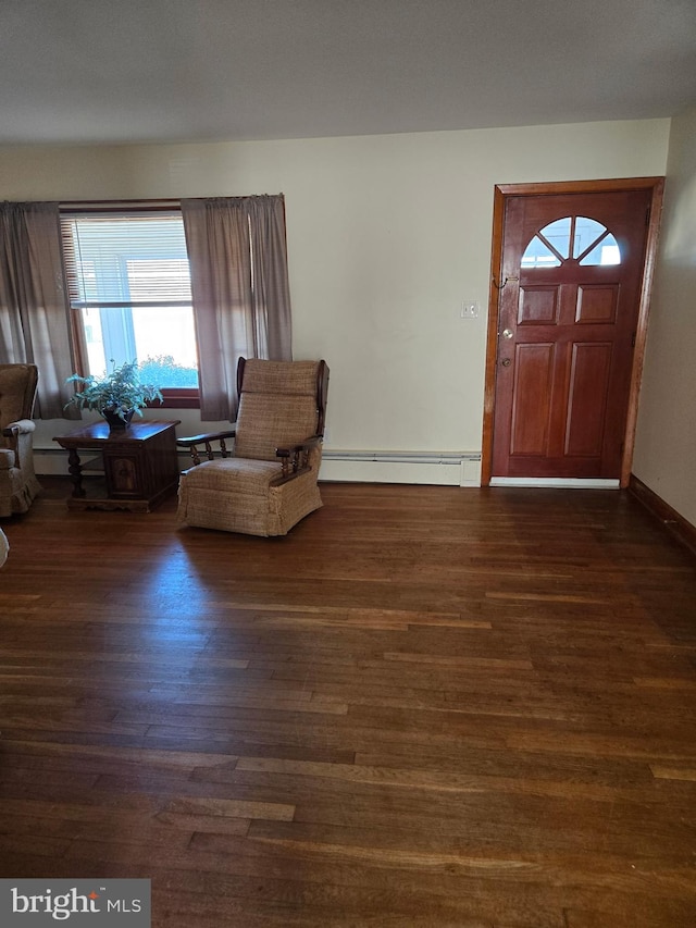 entryway featuring a baseboard heating unit, baseboards, and wood finished floors