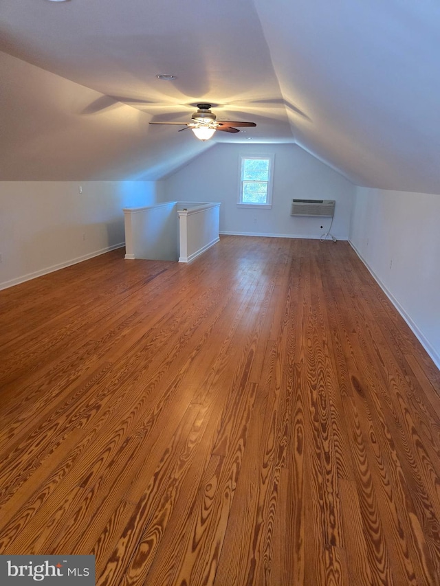 bonus room with vaulted ceiling, ceiling fan, wood finished floors, and baseboards