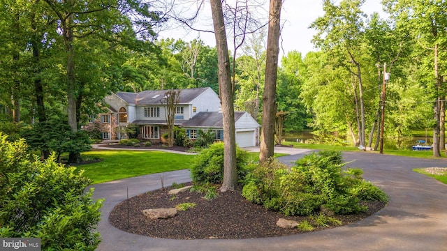 view of front of home with a front yard and a garage