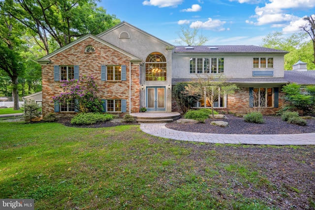 view of property with a front yard and french doors