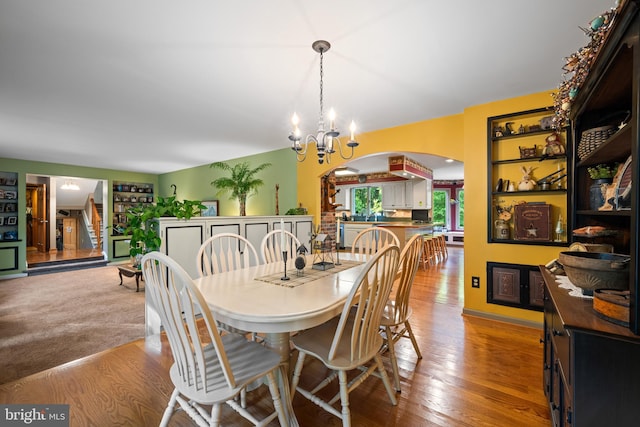 dining area featuring a notable chandelier and light wood-type flooring