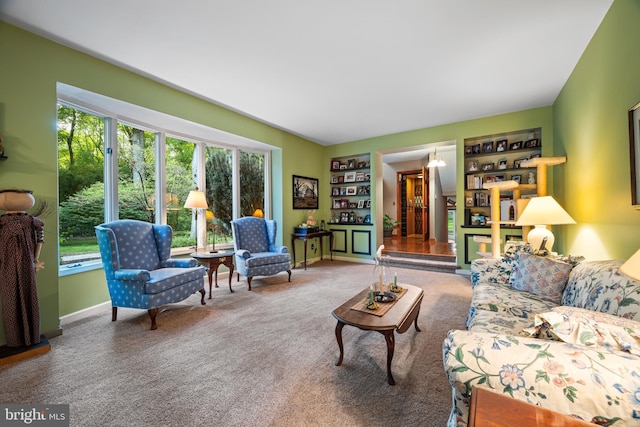 living room with built in features, a chandelier, and carpet