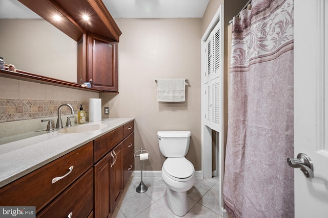 bathroom featuring vanity, toilet, tasteful backsplash, and tile patterned flooring