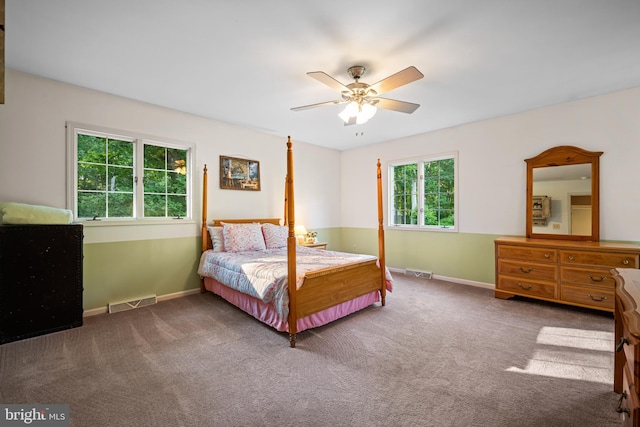 bedroom featuring ceiling fan and dark carpet