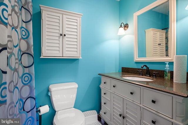 bathroom featuring toilet and vanity