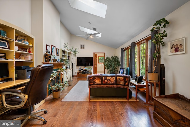 office space featuring lofted ceiling with skylight and wood-type flooring