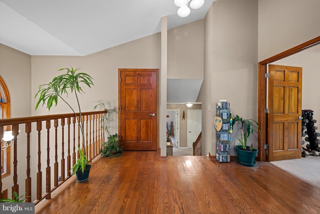 entrance foyer with vaulted ceiling and hardwood / wood-style flooring