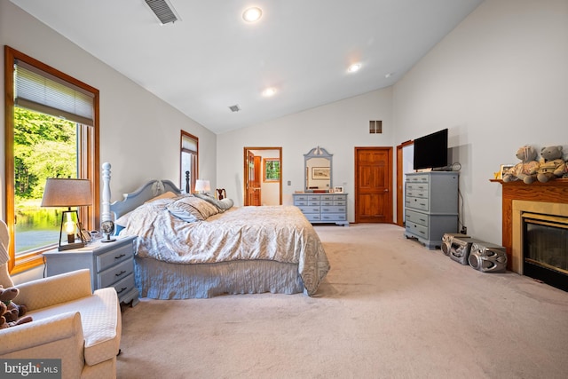 carpeted bedroom featuring high vaulted ceiling