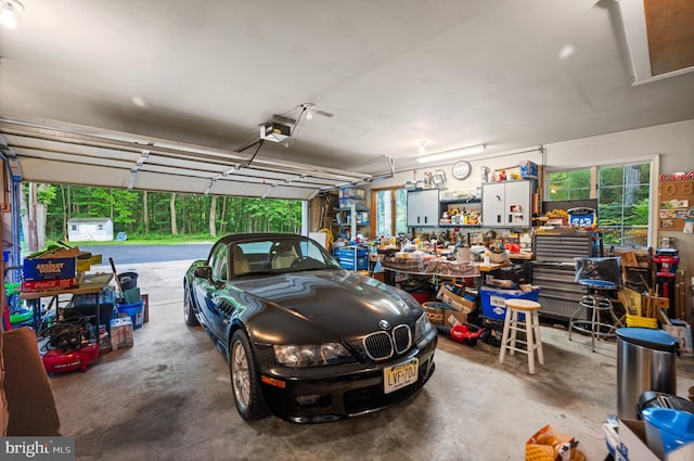 garage with a garage door opener and a workshop area