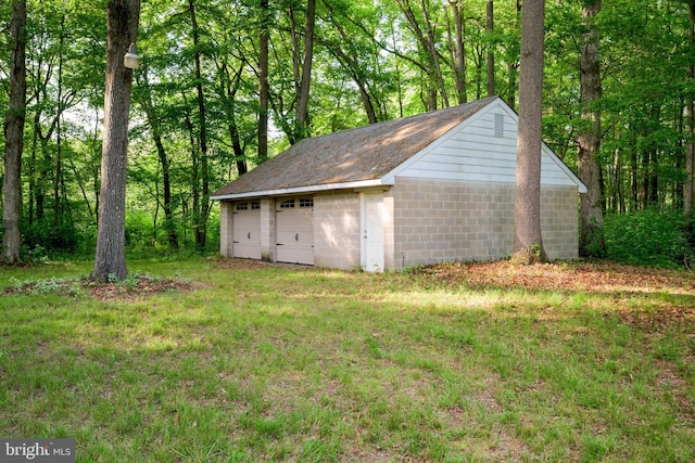 exterior space featuring a garage and a yard