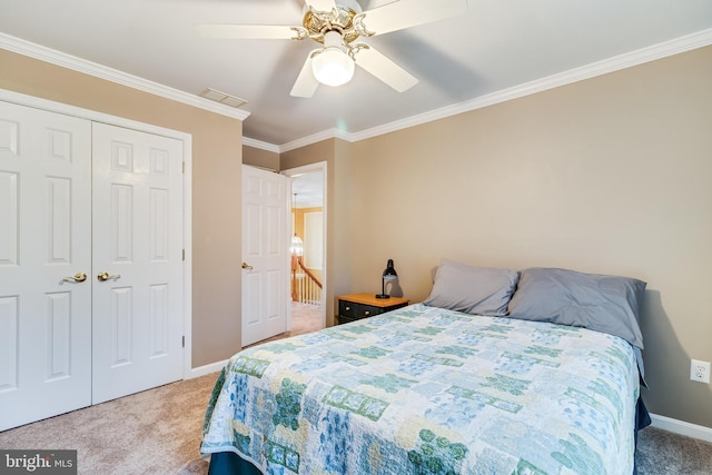 bedroom with baseboards, ceiling fan, ornamental molding, a closet, and light colored carpet