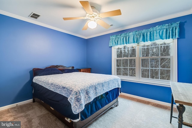 carpeted bedroom with visible vents, ceiling fan, crown molding, and baseboards