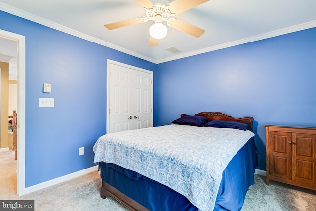 bedroom with ceiling fan, baseboards, ornamental molding, light carpet, and a closet