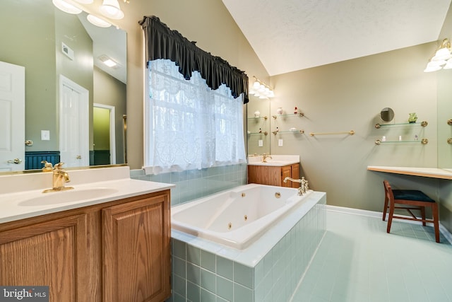 bathroom featuring visible vents, two vanities, a sink, a jetted tub, and vaulted ceiling