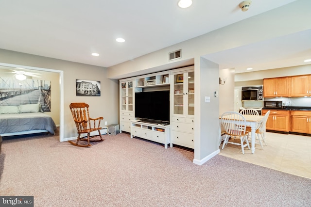 living area with visible vents, a ceiling fan, recessed lighting, baseboards, and light colored carpet