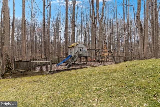 view of jungle gym featuring a lawn and fence