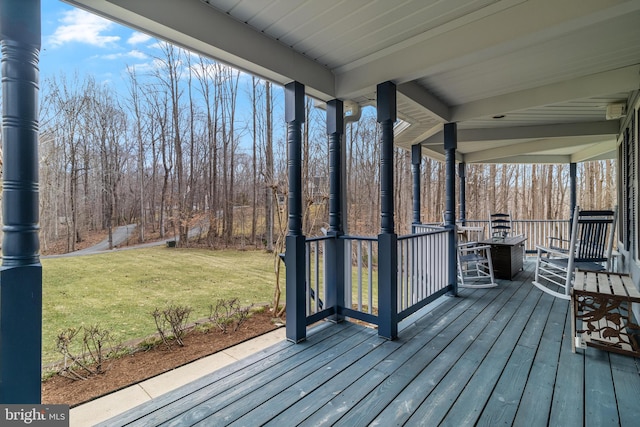 deck featuring a porch and a lawn