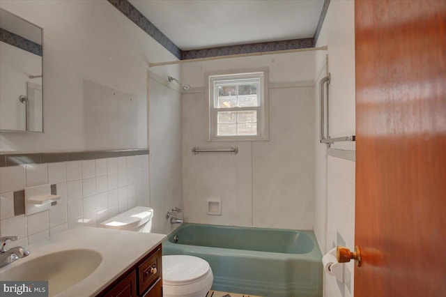 full bathroom featuring shower / bathtub combination, tile walls, toilet, and vanity