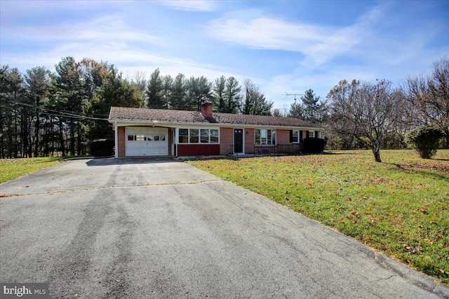 ranch-style house with a garage and a front lawn