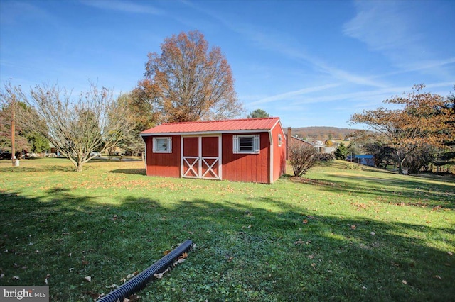 view of outdoor structure featuring a lawn