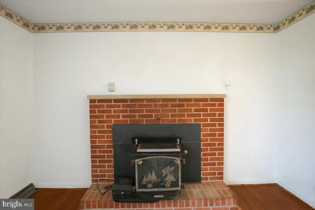 room details with hardwood / wood-style floors and a wood stove