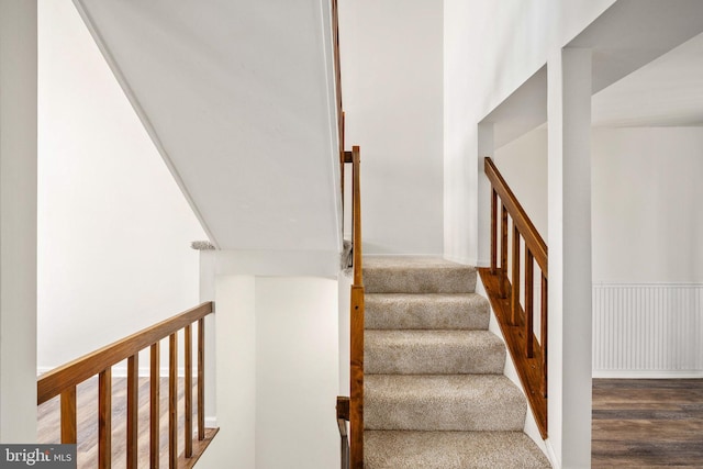 stairs featuring hardwood / wood-style flooring