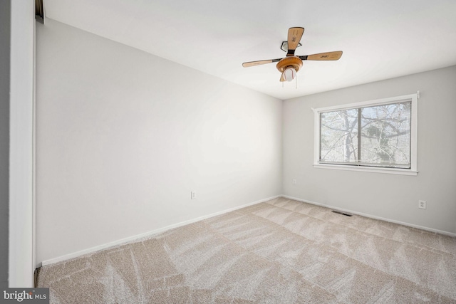 empty room with light carpet and ceiling fan