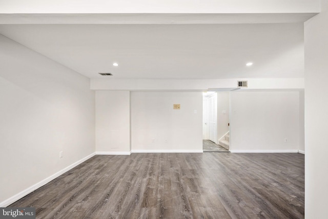 unfurnished room featuring dark wood-type flooring