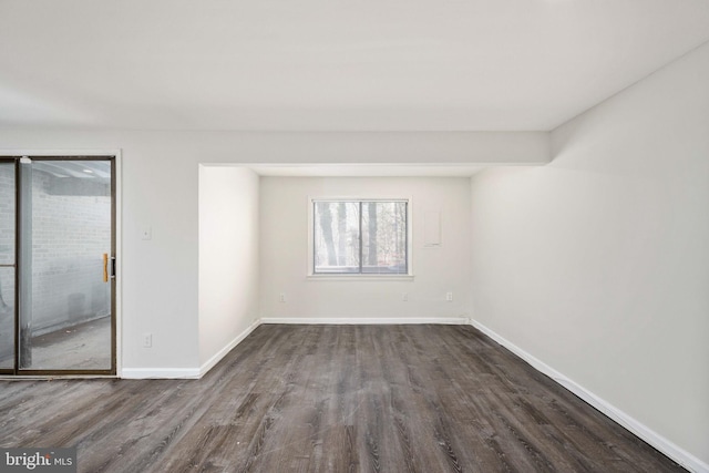 spare room featuring dark hardwood / wood-style flooring