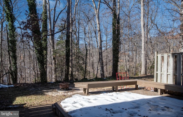 exterior space with a playground and a fire pit