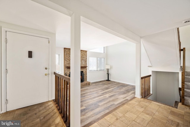 foyer with a fireplace and light hardwood / wood-style floors