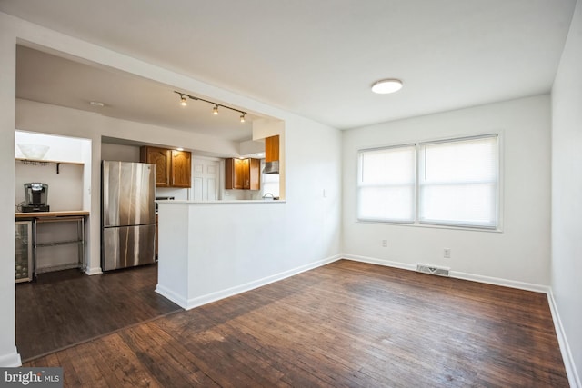 kitchen with dark hardwood / wood-style floors, wine cooler, stainless steel fridge, kitchen peninsula, and wall chimney range hood