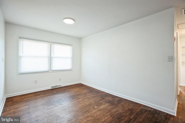 empty room with dark wood-type flooring