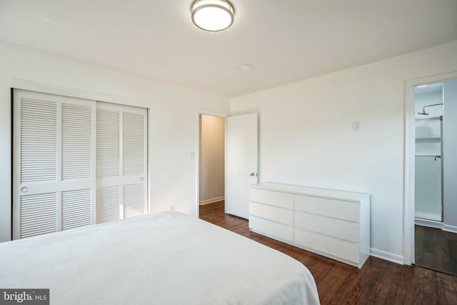 bedroom featuring dark hardwood / wood-style flooring and a closet