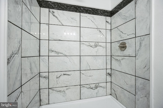 bathroom with a tile shower